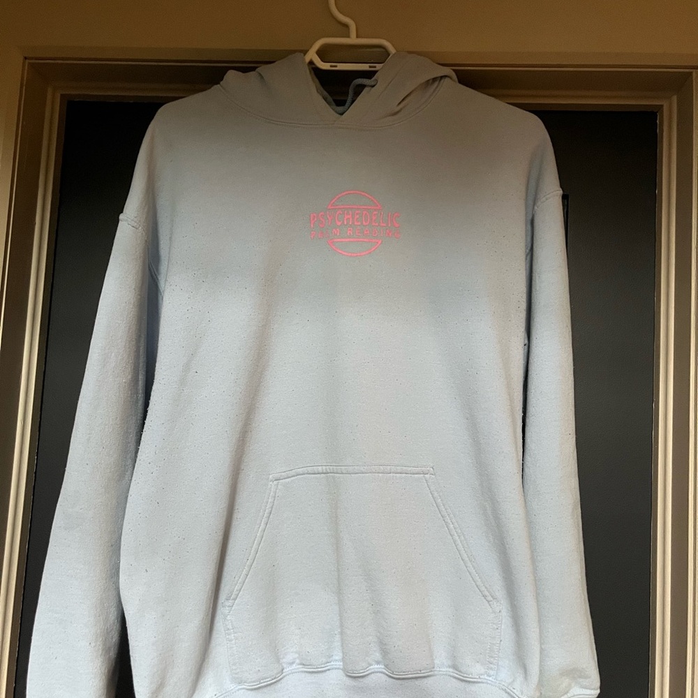 Psychedelic baby blue hoodie with pink writing